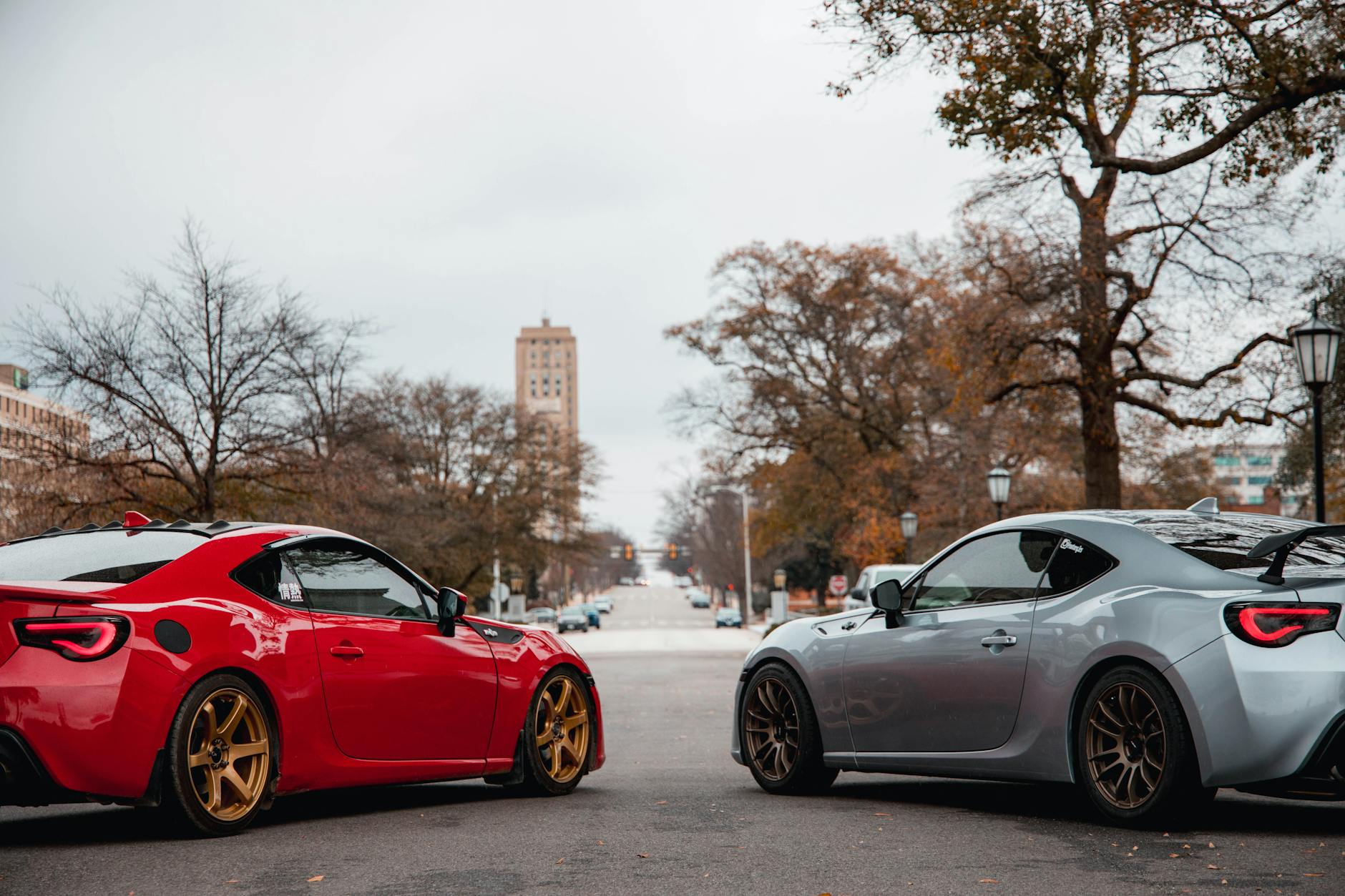 two luxury sports cars in a city