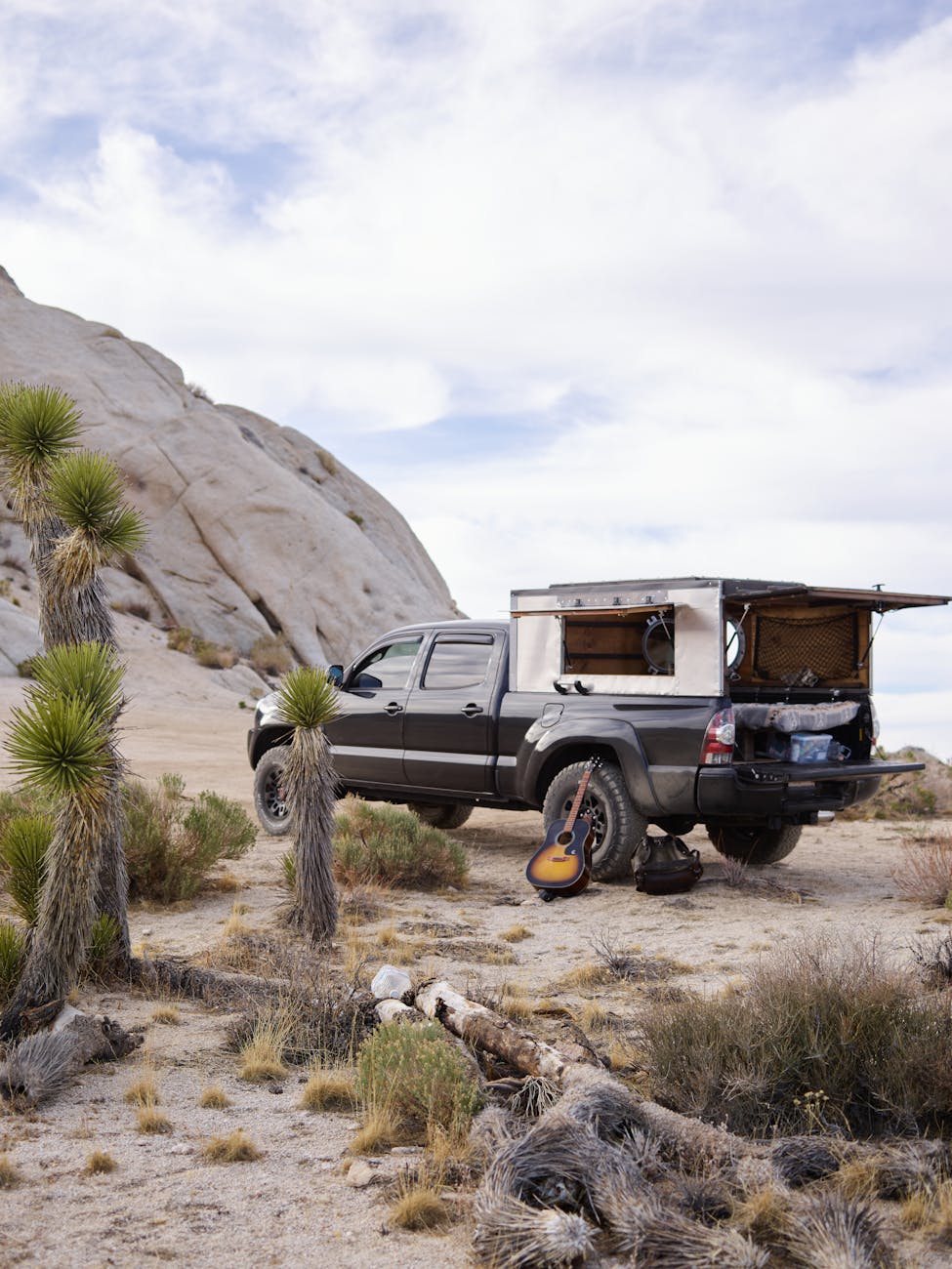 black pick up truck parked on the desert