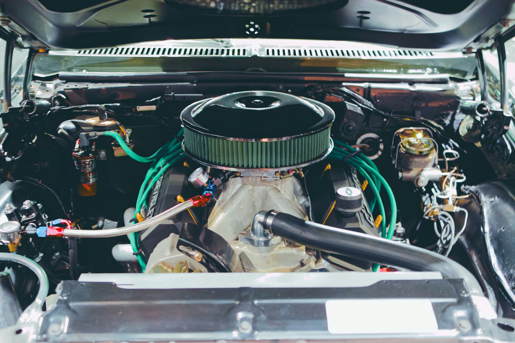 Close-up of a classic carbureted V8 engine in a restored engine bay