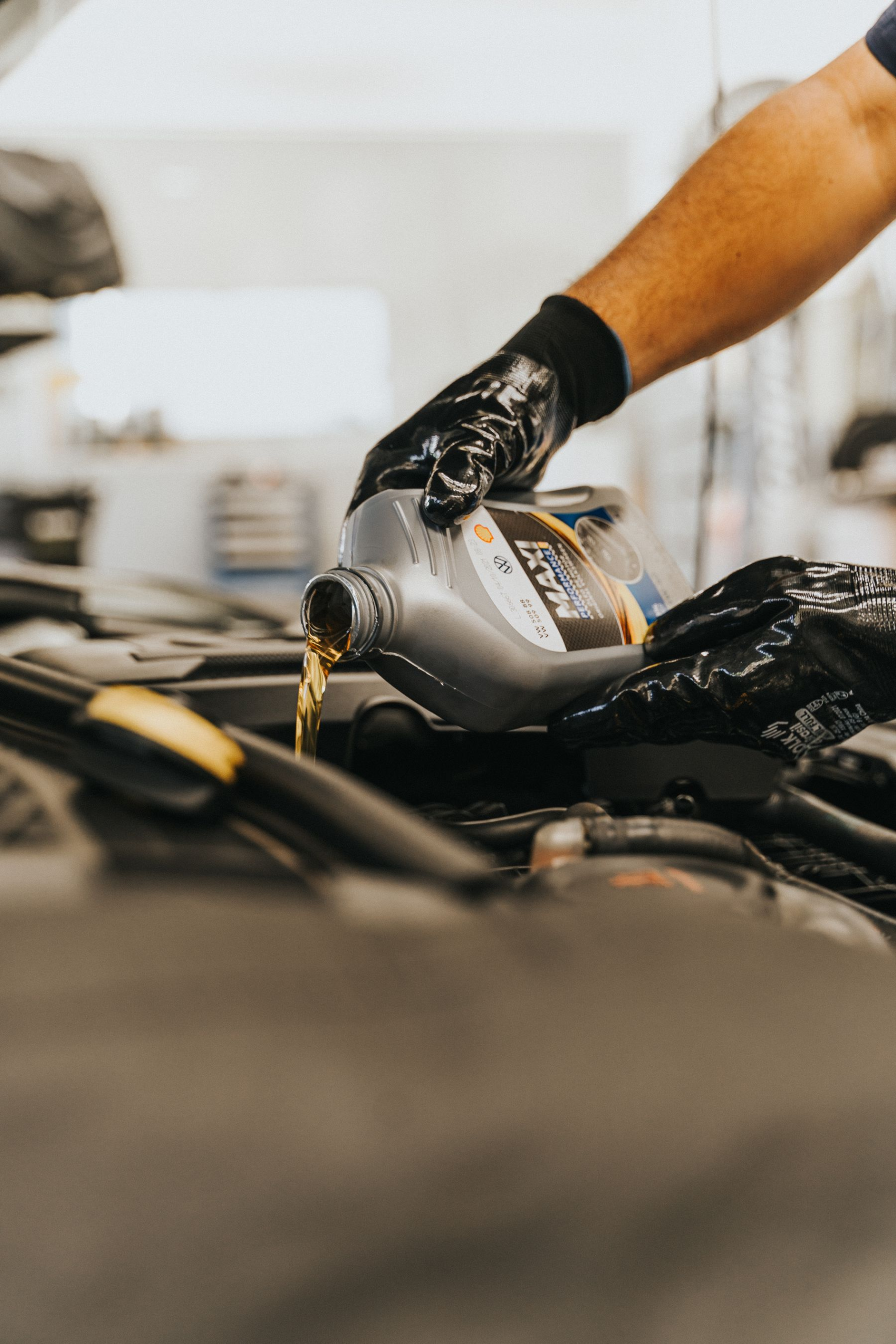 Close-up of fresh engine oil being poured in during an oil change
