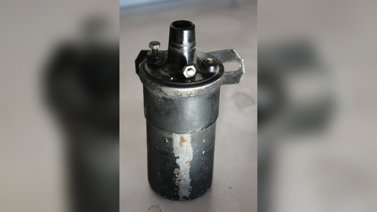Classic canister ignition coil with primary terminals and coil tower, the kind used with a ballast resistor